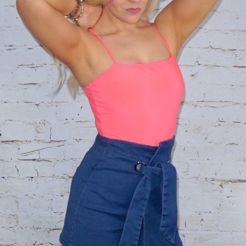 Neon pink bodysuit feat spaghetti straps & snap-bottom closure